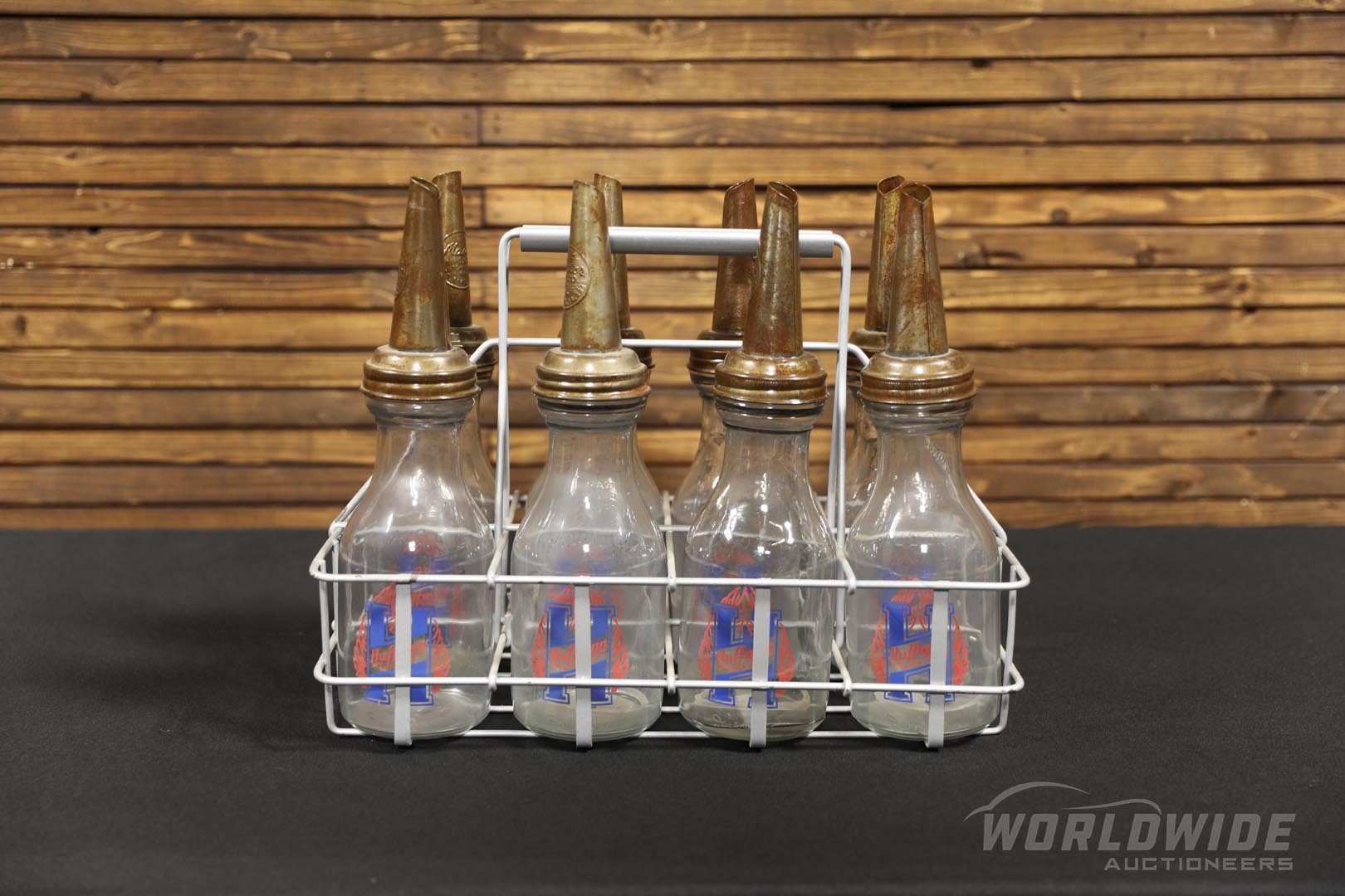 Eight Oil Bottles with Vintage Carrying Rack